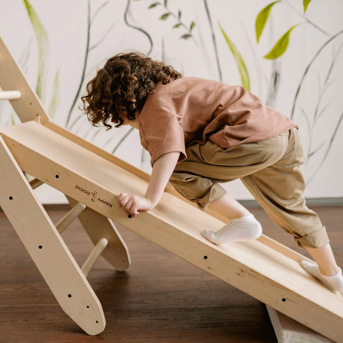Child climbing on a balance toy