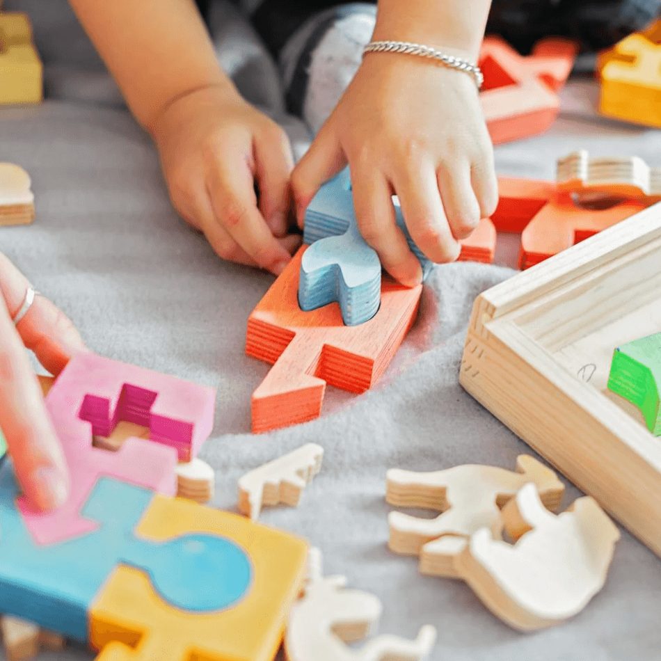Child playing with intricate wooden puzzle toys